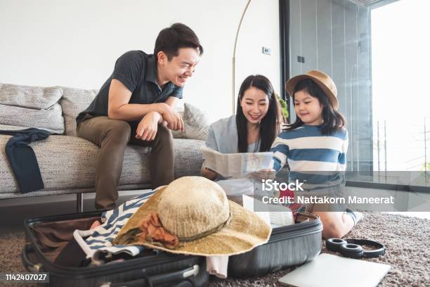 Asian Family Packing Bag Luggage And Planning To Travel On Summer Vacation Stock Photo - Download Image Now