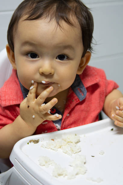 istock Cute baby boy eating rice 1142409677
