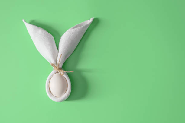 istock Easter table decoration with napkin in the form of rabbit ears and eggs. 1142409831