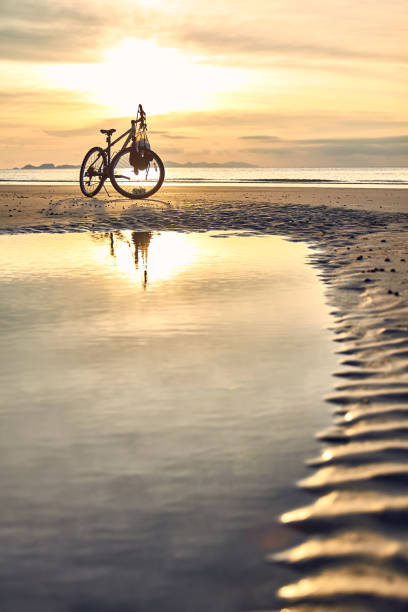 istock biking on punte malaka beach during sunset, koh tarutao 1142413067