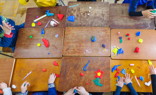 istock Children playing with clay in classroom 1142414477