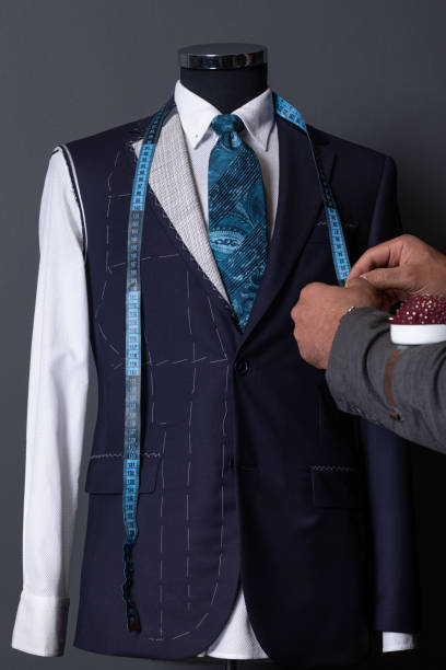 man measuring jacket on male dress form - fashion men fashion model male imagens e fotografias de stock