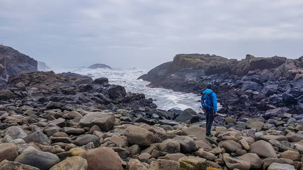 istock Iceland - A young man and the sea 1142416894