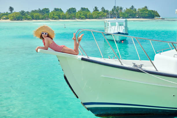 istock Woman in red bikini lying on boat bow 1142417327
