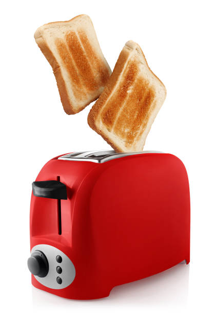 Toasts and a toaster on white Roasted toasts popping out of a red toaster, isolated on white background toaster stock pictures, royalty-free photos & images