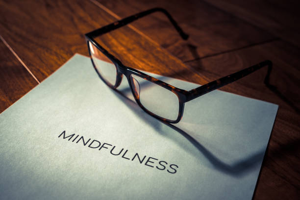 istock Mindfulness word title printed on paper highlighted on a wooden walnut floor 1142418983