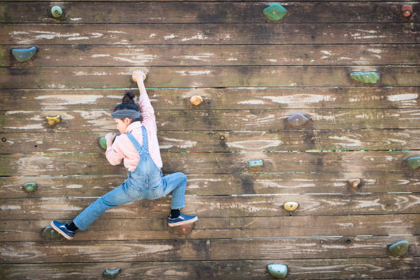 istock Girl climbing a wall 1142419525
