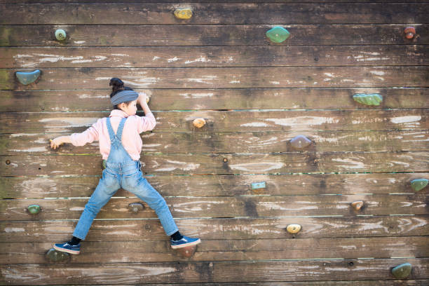 istock Girl climbing a wall 1142419530