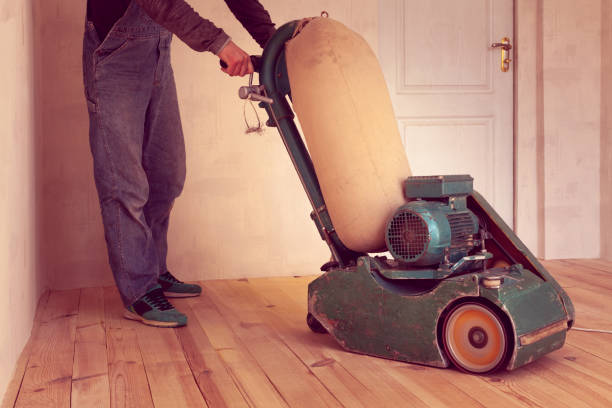 istock carpenter works by electric grinding wood machine in a room 1142420171