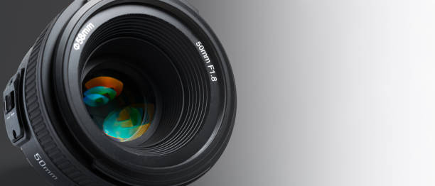 A modern photographic lens with a 50mm focal length on a white background stock photo