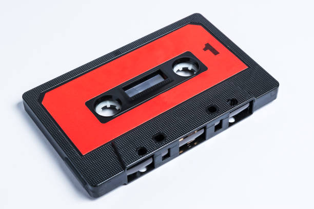 istock A red and black audio cassette with roll-up tape and isolated on white background 1142422503