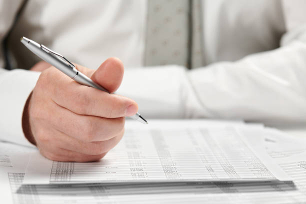 istock Businessman working in an office. Hands and documents closeup. 1142423340