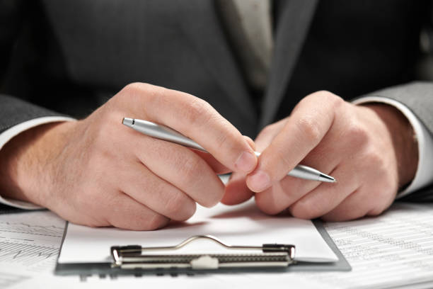 istock Businessman working in an office. Hands and documents closeup. 1142423371