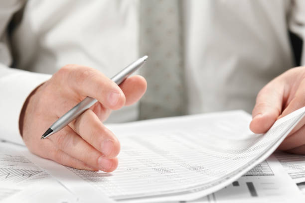 istock Businessman working in an office. Hands and documents closeup. 1142423393