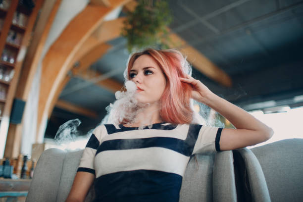 istock Young woman smoking electronic cigarette. Vape concept. 1142424215