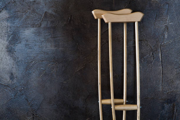 istock wooden crutches on the  grungy wall. 1142425467