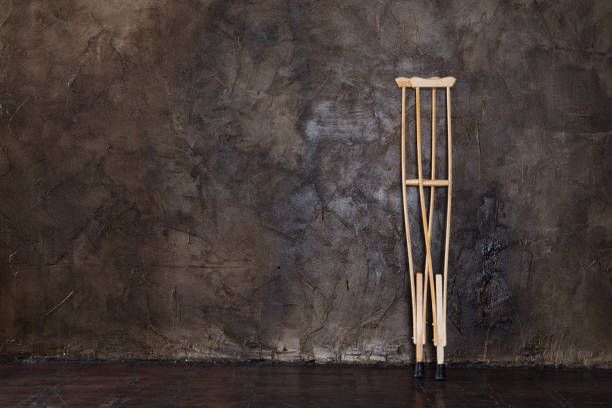 istock wooden crutches on the  grungy wall. 1142425471