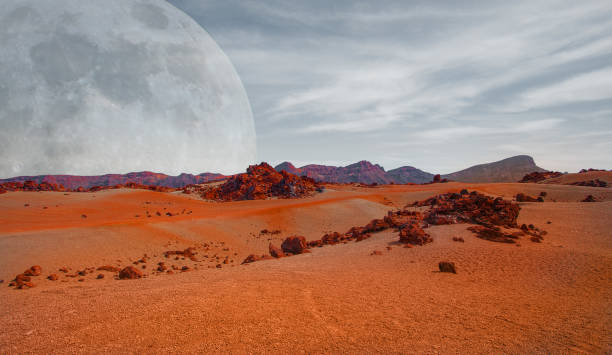 Red planet with arid landscape, rocky hills and mountains, and a giant Mars-like moon at the horizon, for space exploration and science fiction backgrounds. Elements of this image furnished by NASA. Red planet with arid landscape, rocky hills and mountains, and a giant Mars-like moon at the horizon, for space exploration and science fiction backgrounds. Elements of this image furnished by NASA. mars stock pictures, royalty-free photos & images