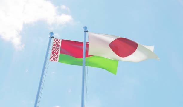 istock Belarus and Japan, two flags waving against blue sky 1142425846