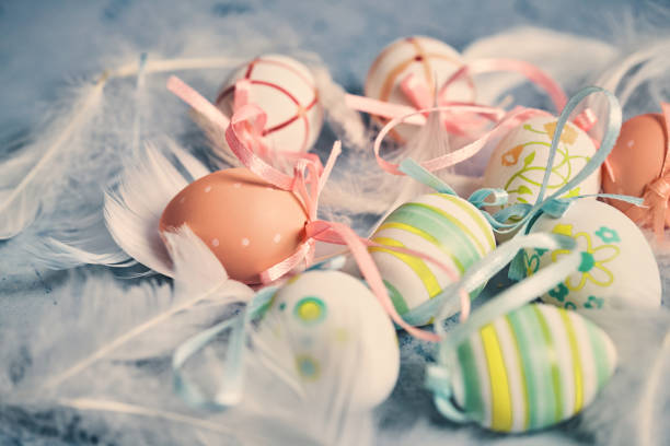 Colorful Easter eggs decoration on wooden background. They can be painted in various colors and can be given on Easter or springtime.