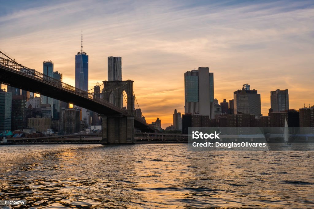 View of the Brooklyn bridge during a dusk from East river. New York City Brooklyn Bridge Stock Photo