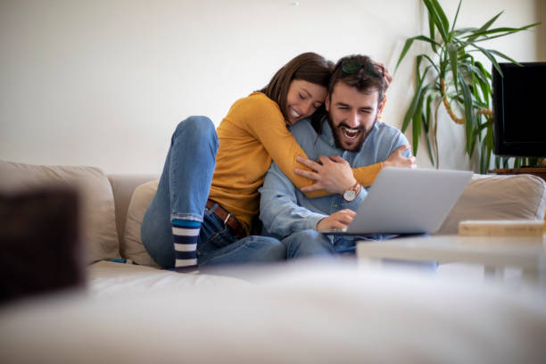 istock Young married couple in the living room with a computer 1142427741