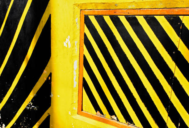 istock Orange window frame in a bright yellow painted wall 1142433026