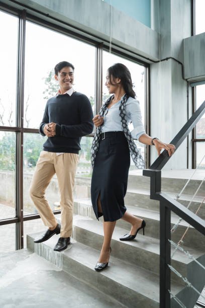 istock business people walking on stairs in the office 1142436363