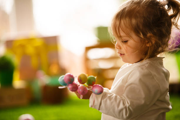 istock Baby girl playing with Easter eggs 1142436770