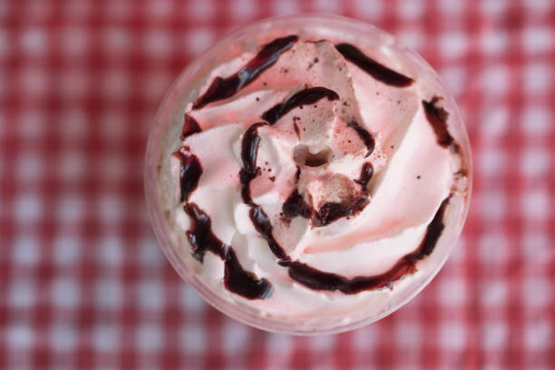 istock Soft Ice cream on top iced drink with red and white pattern 1142436813
