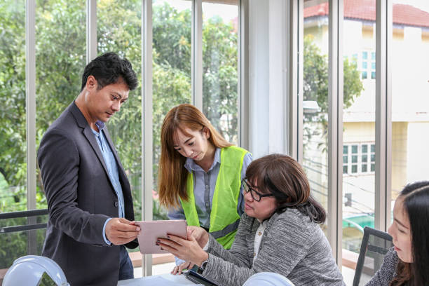 istock The engineering team is meeting the layout and structure. The engineering team is planning an event with joy. Group engineers discussing work in meeting room at the office. 1142438127