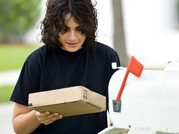 Photo of Male Teen receiving a package