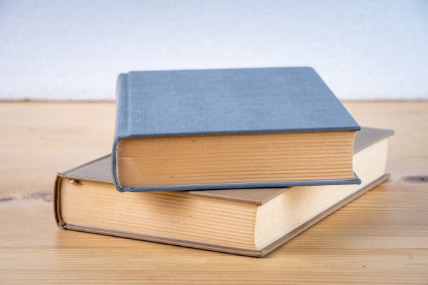 istock Two books on the wooden table, education 1142440603