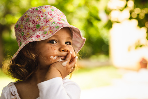 Baby Girl Smearing Ice Cream On Her Face Stock Photo - Download Image Now -  Ice Cream, Melting, Springtime - iStock