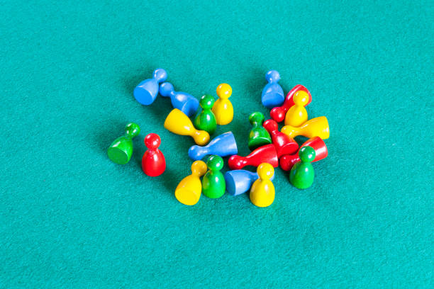 istock wooden board game pawns on green table 1142442102