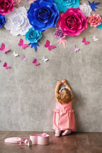 istock Little girl playing with wall decoration 1142443703