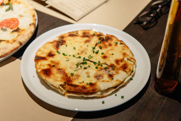 istock Puccia Al Tarfuto: Thin crispy dough filled with mascarpone, stracciatella, parmesan and black truffle. 1142443955