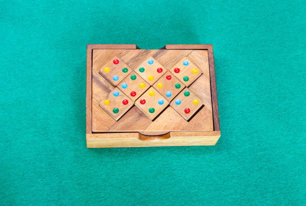 wooden box with puzzle on green baize table