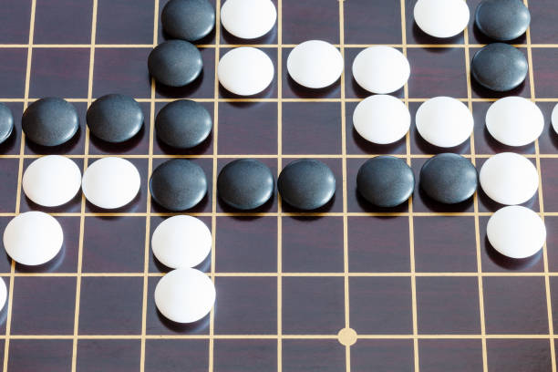 istock playing in Go game on wooden board 1142446009