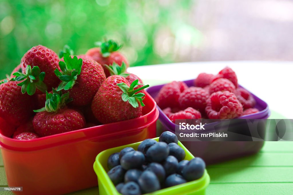 Berry good for you! Healthy summer berries in colourful containers. This image was captured using a Canon 1Ds MkII, L series lens. Arrangement Stock Photo