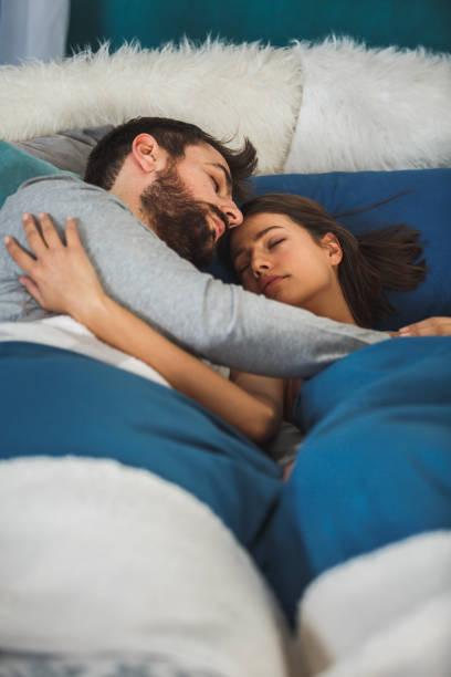 istock Young couple sleeping together in bedroom 1142448564