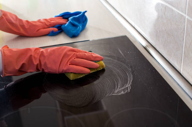 istock Woman cleaning induction stove 1142448865
