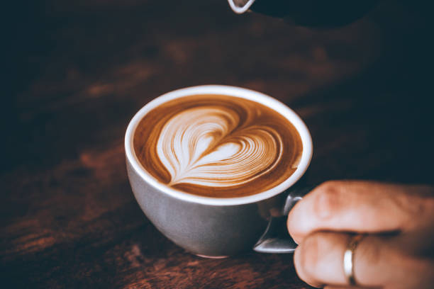 istock Barista making pouring stream milk with coffee latte art pattern heart shape. 1142450818