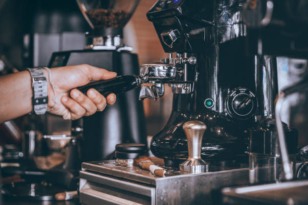istock barista making coffee freshly roasted make beans into powder with machine. 1142450838