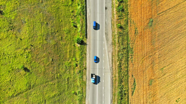 istock Aerial view of a traffic on a highway between two fields 1142451086