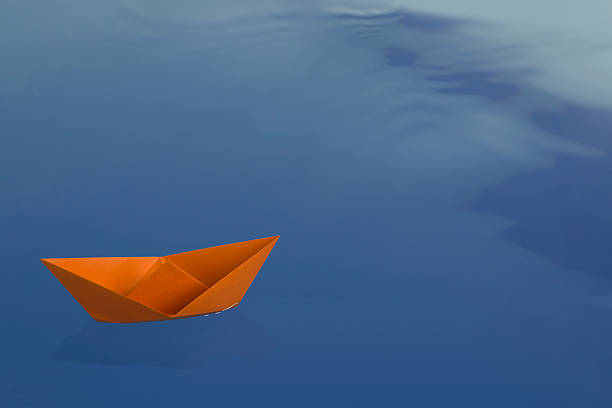 istock Orange tranquil origami boat 114245214