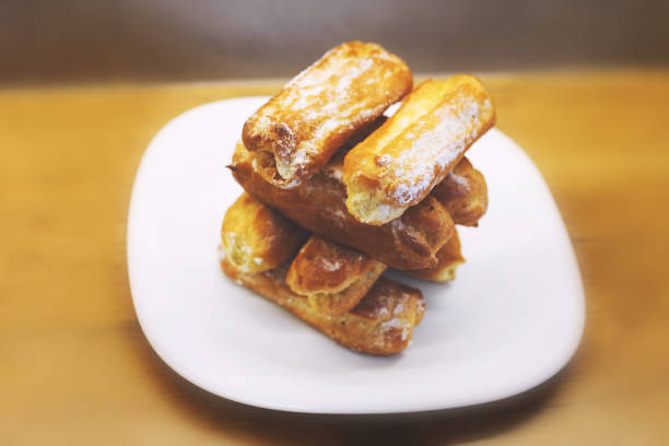 istock eclairs cakes lie on a white plate.  sweet cakes eclairs 1142452641