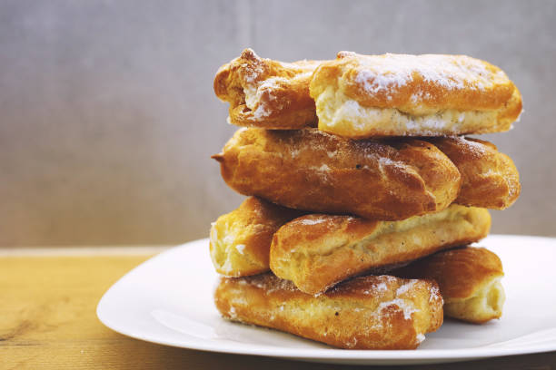 istock eclairs cakes lie on a white plate.  sweet cakes eclairs 1142452692
