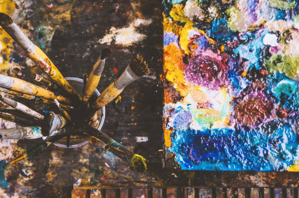 istock Color fragments stained on paper sheets from art and paint brushes. 1142452980