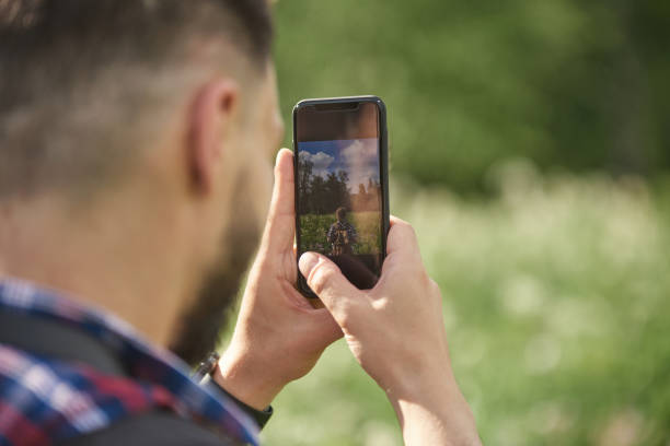 istock Man taking photo outdoor 1142453357